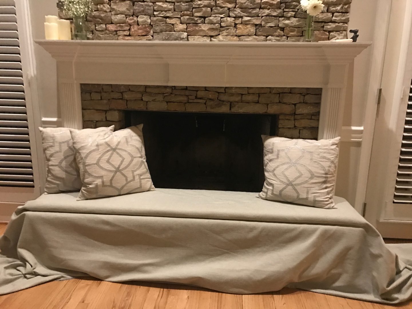 Baby proofed fireplace created with foam bench over the hearth and bookcase  insert